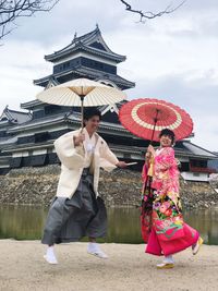 People at traditional clothing against sky