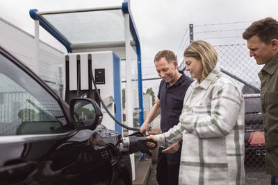 Customers charging in car dealership