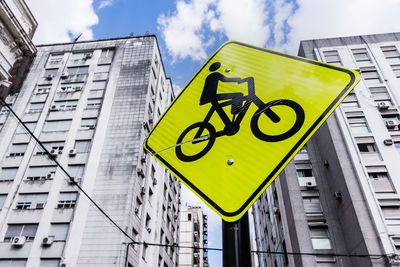 Low angle view of road sign against sky