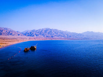 Scenic view of sea against clear blue sky