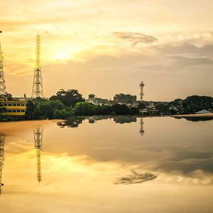 Scenic view of river against sky at sunset