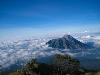 Scenic view of snowcapped mountains against blue sky