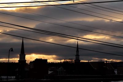 Low angle view of silhouette buildings against sky during sunset