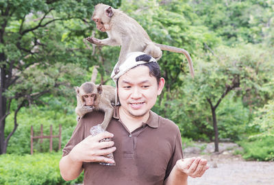 Man feeding monkeys at zoo