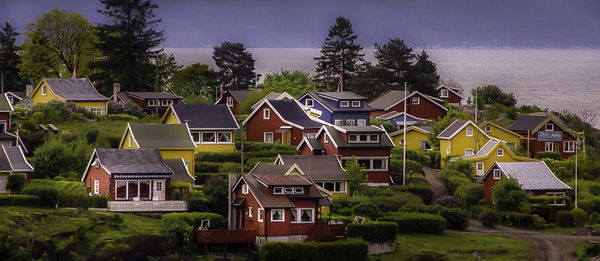 Houses in city against sky