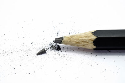 High angle view of pencils on table against white background