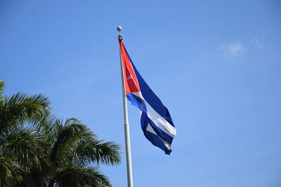 Low angle view of flag against clear blue sky