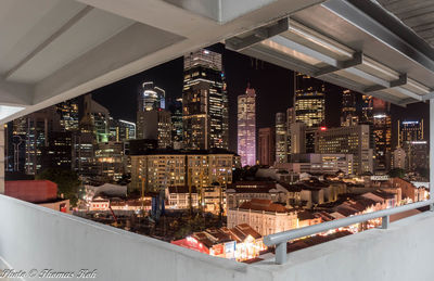 High angle view of illuminated buildings in city at night
