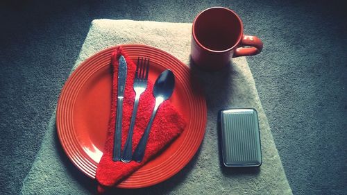 High angle view of fork and spoon in plate