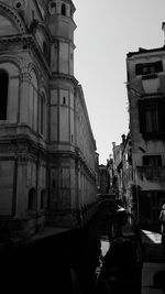 Street amidst buildings against sky in city