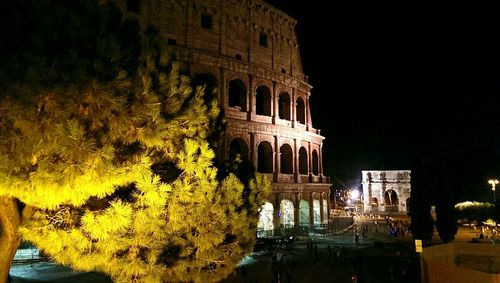 Illuminated built structure against sky at night