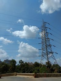 Low angle view of birds on electricity pylon against sky