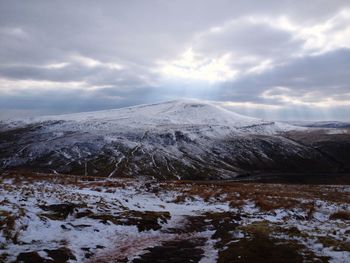 Scenic view of snow covered mountains against sky