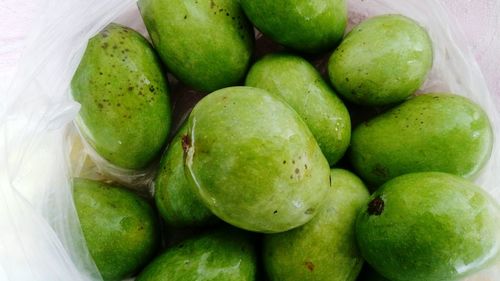 High angle view of raw mangoes in plastic