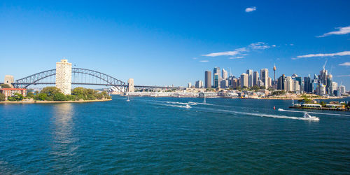 View of bridge over sea against buildings in city