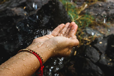 High angle view of woman hand in water