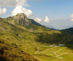 Scenic view of mountains against cloudy sky