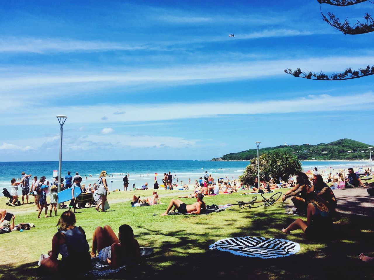 PEOPLE ENJOYING AT BEACH AGAINST SKY