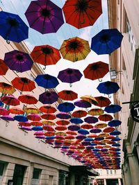 Low angle view of colorful umbrellas in city