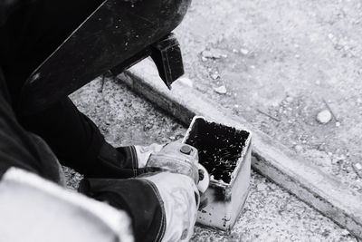 High angle view of man cutting metal at construction site