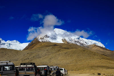 Scenic view of snowcapped mountains against blue sky