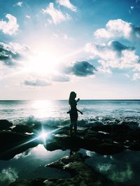 Man standing on beach against sky