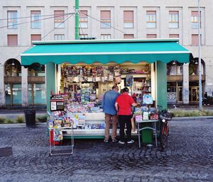 People standing at store in city