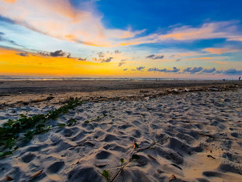 Scenic view of beach against sky during sunset