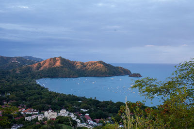 Scenic view of sea and mountains against sky