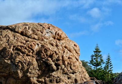 Low angle view of rock formation against sky