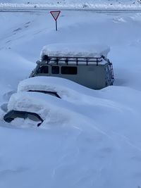 Snow covered boat against blue sky