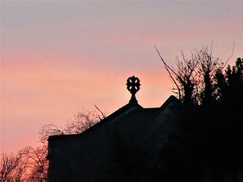 Silhouette trees against sky during sunset