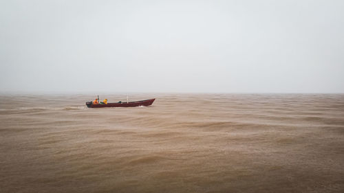 Boat in sea against clear sky