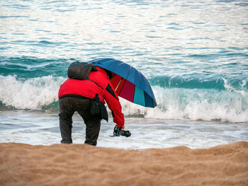Rear view of person standing on beach