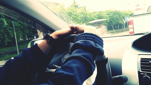 Midsection of man sitting in car