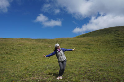 Full length of woman on landscape against sky