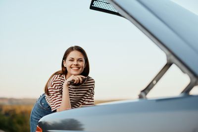 Portrait of smiling young woman in car