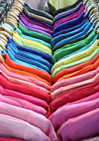 Full frame shot of multi colored shirts hanging in store