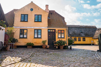 Beautiful, small, yellow rustic houses. traditional scandinavian style.