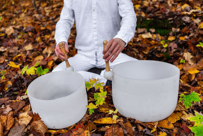 Midsection of man holding autumn leaves