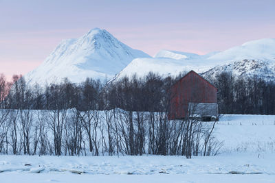 Built structure on snow covered mountain against sky