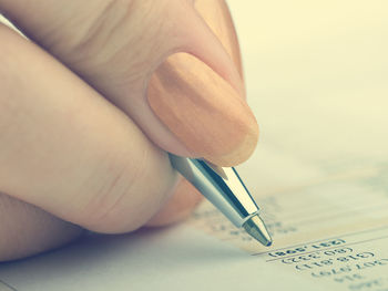 Close-up of woman hand holding paper