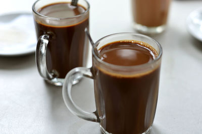 Glass of chocolate milk on table