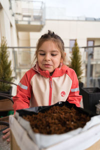 Portrait of young woman holding food
