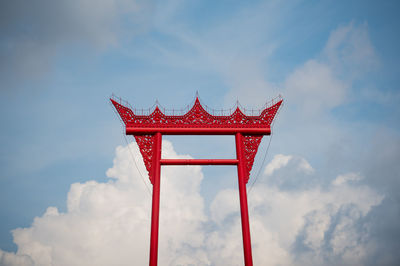 Low angle view of cross against sky