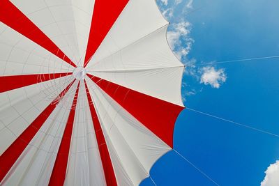 Low angle view of flag against blue sky