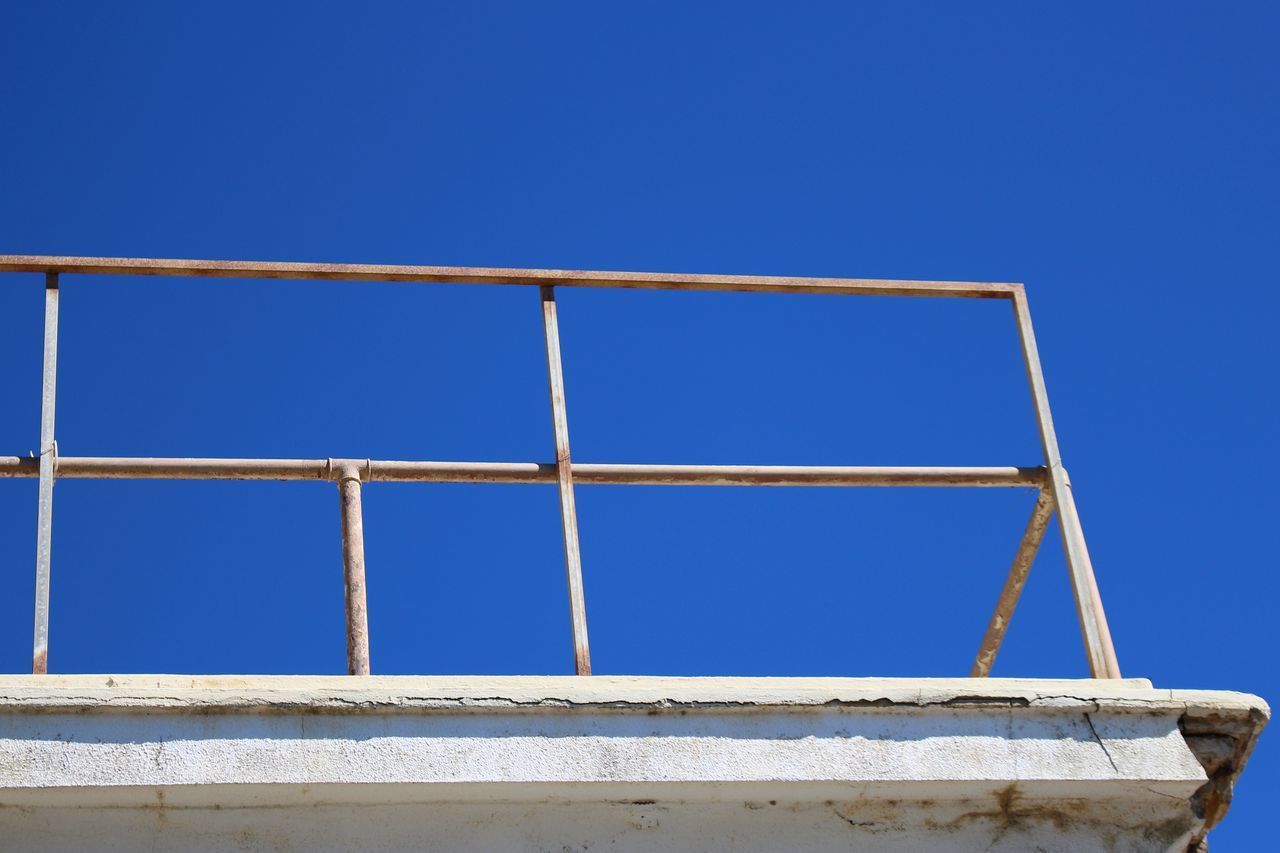 LOW ANGLE VIEW OF CRANE AGAINST BLUE SKY