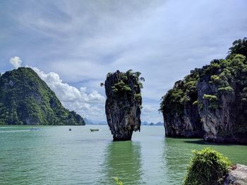 Scenic view of rocks in sea against sky