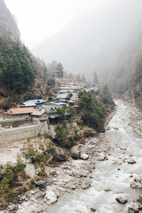 Scenic view of trees and buildings against sky