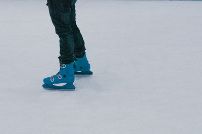 Low section of person standing on snow